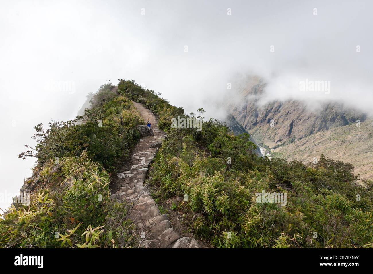 brick pathway to the top of the hill in Andean mountains sacred valley Peru foggy landscape Stock Photo