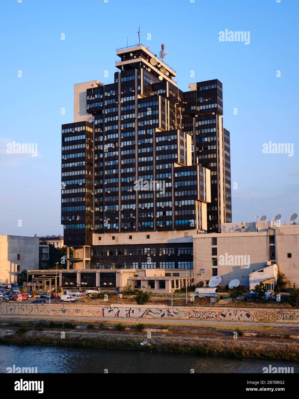 MRT Center building, home of North Macedonian Radio television on the Vardar riverside at sunset in Skopje Stock Photo