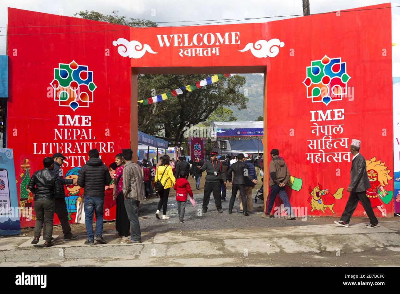 Nepalese People walking by Entrance to Annual Nepal International
