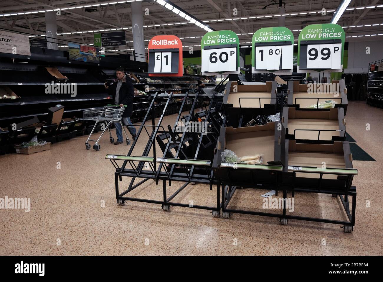 Empty shelves in the fruit and vegetable section of an Asda store in