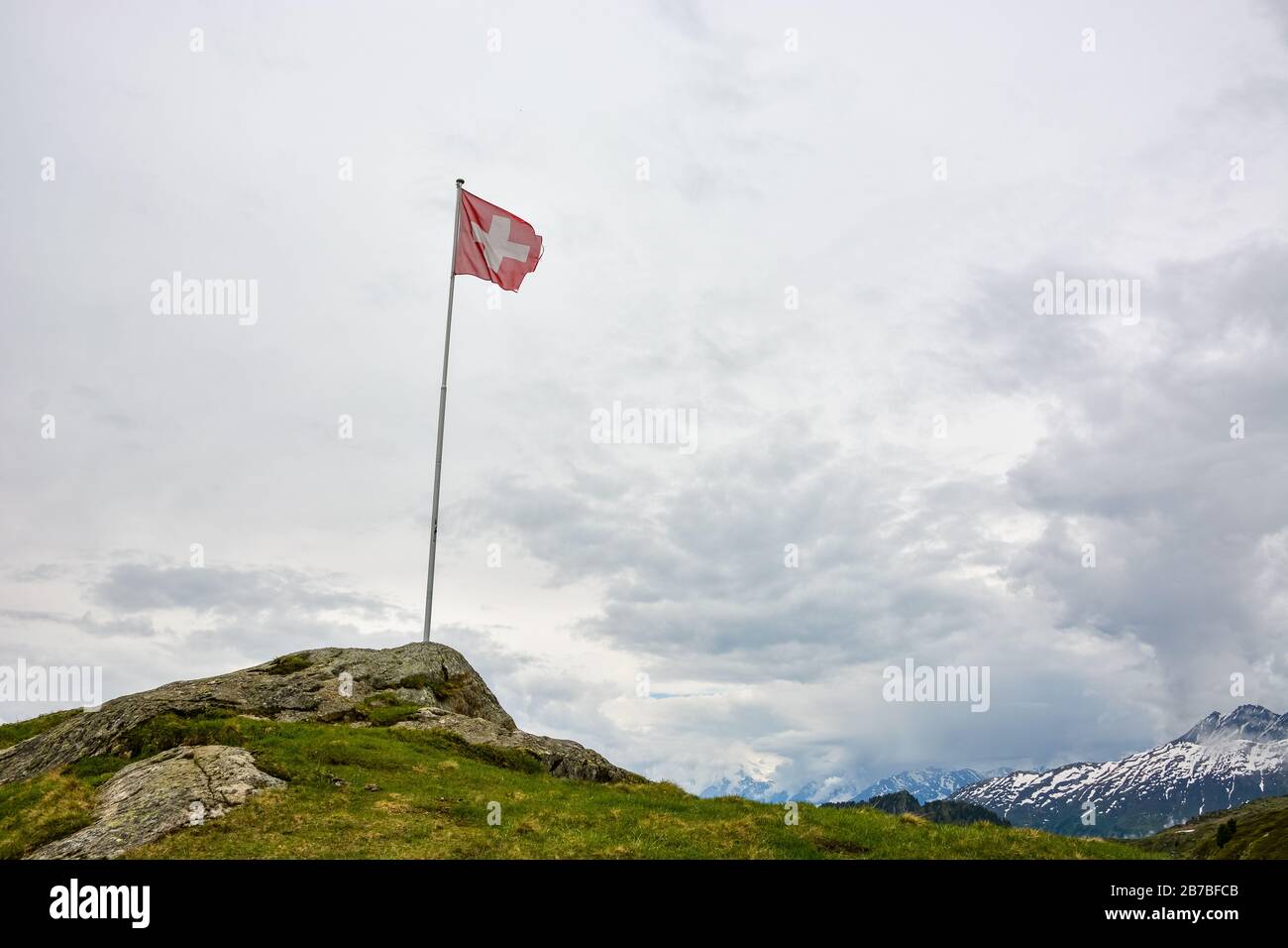 A Swiss flag in the swiss mountains near Bettmeralp and Aletsch glacier Stock Photo