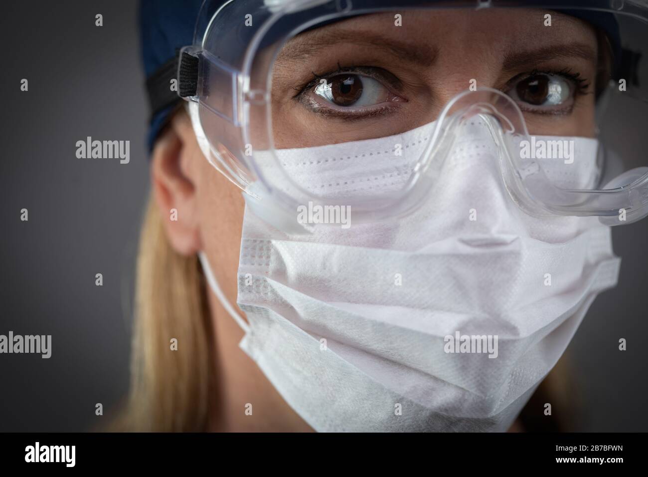 Female Medical Worker Wearing Protective Face Mask and Gear Against ...