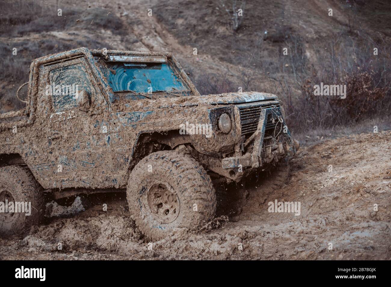 4x4 offroad jeep in the mud. Sport and activitiy at the hill with professional drivers Stock Photo