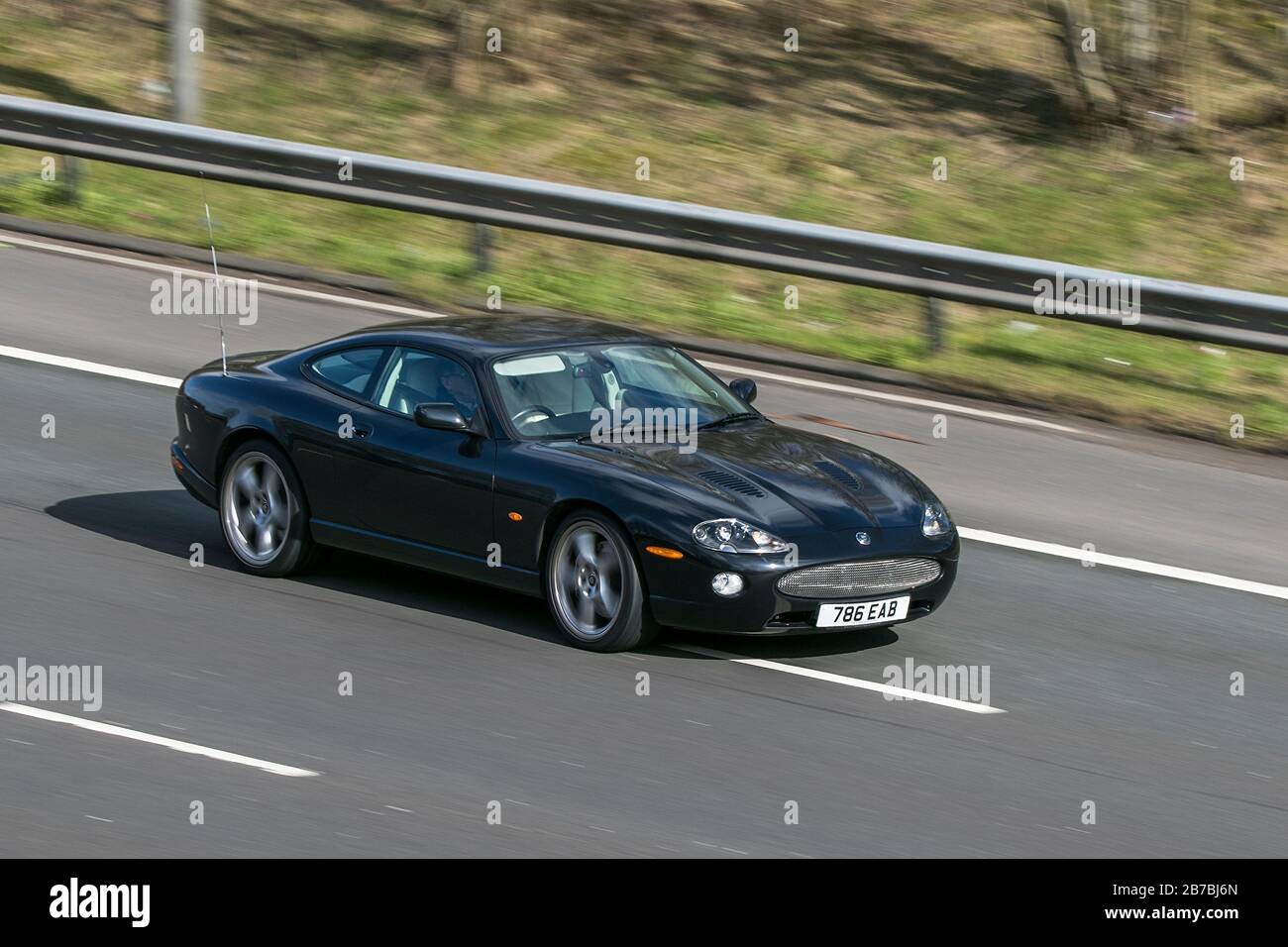 786EAB Jaguar Xkr Coupe Auto Black Car Petrol driving on the M6 motorway near Preston in Lancashire, UK Stock Photo