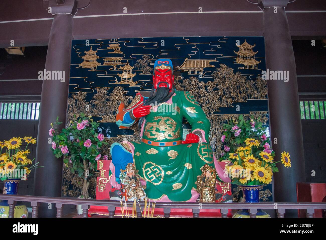 Guilin, China - May 11, 2010: Qixia Buddhist Temple in Seven Star Park. Closeup of Statue of Red-faced, green-golden garb, Guan Yu God of War surround Stock Photo