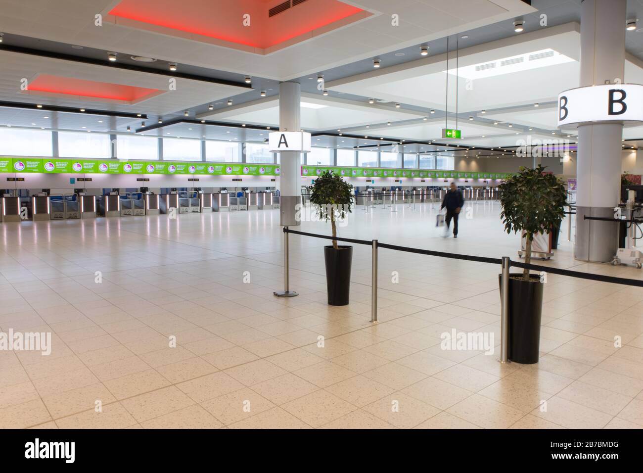 London, UK, 14th March, 2020.  Airline check-in desks at London Gatwick Airport are silent and empty as news breaks of the decision by US President Donald Trump to ban all travel to the USA from the UK and Ireland. Credit: Brian Wilson/Alamy Live News. Stock Photo