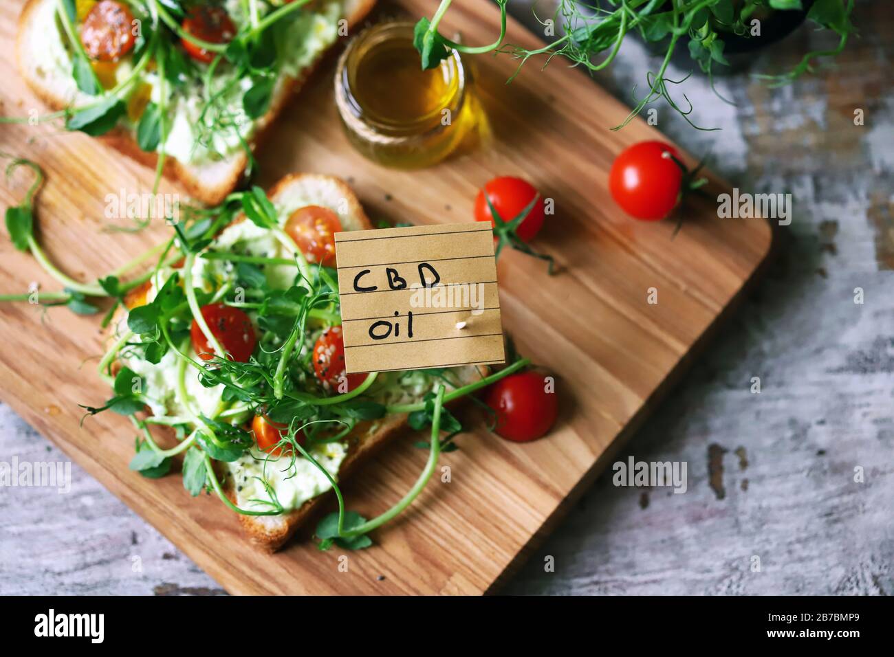Selective focus. Healthy toasts with microgreens and cbd oil. Cannabidiol concept. CBD oil. Cbd food. Stock Photo