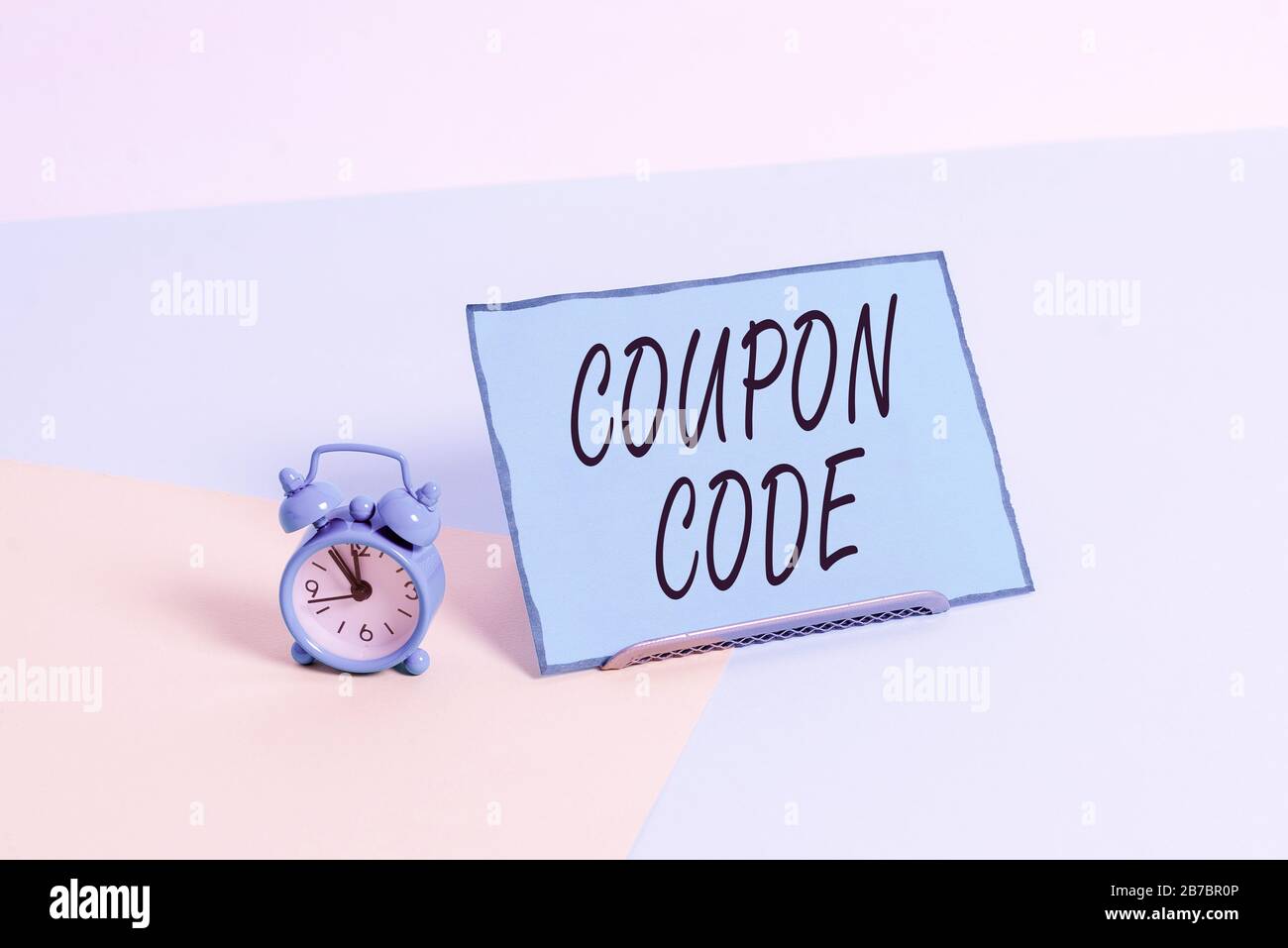 Conceptual hand writing showing Coupon Code. Concept meaning ticket or  document that can be redeemed for a financial discount Alarm clock beside a  Pap Stock Photo - Alamy