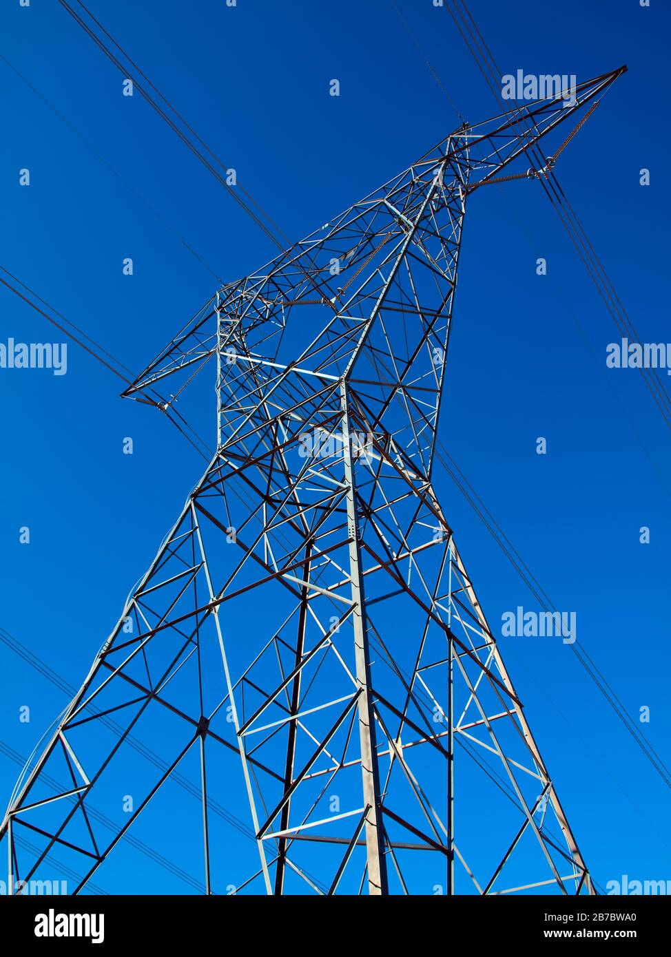 A tall metal tower used to support high voltage powerlines Stock Photo