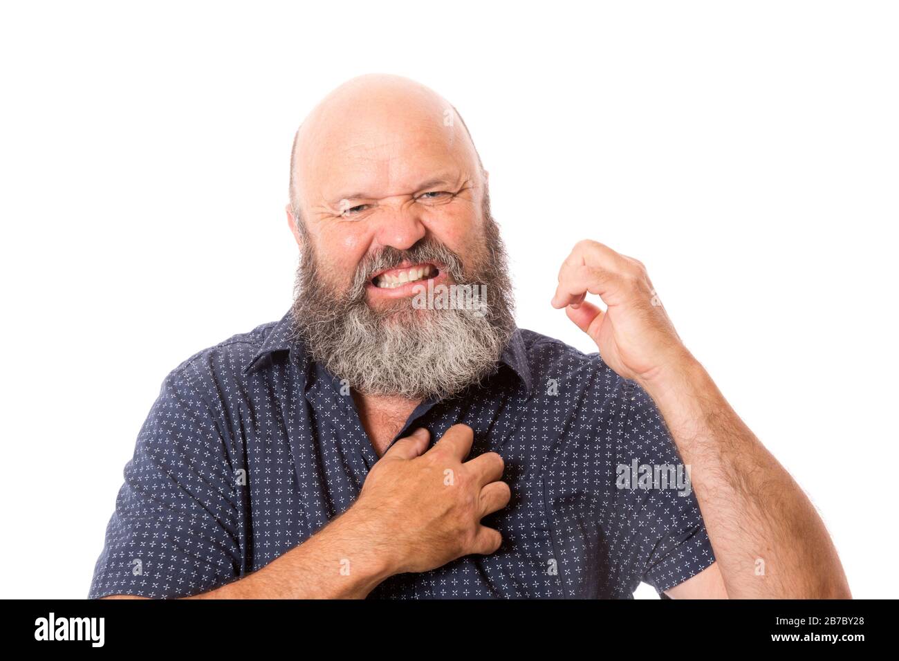 A man with itchy skin scratching himself. Stock Photo