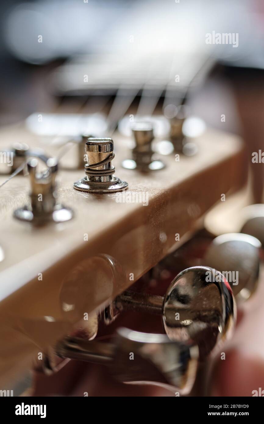String wound on a peg, closeup, on the headstock of an old wooden