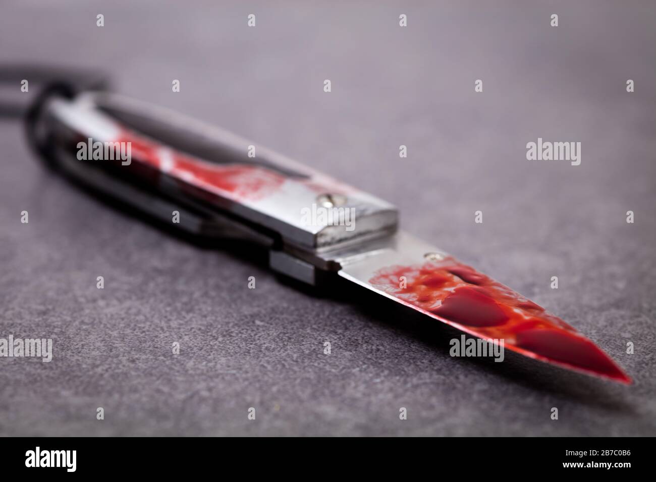 Knife covered in blood. Knife crime and gang related violence. Stock Photo