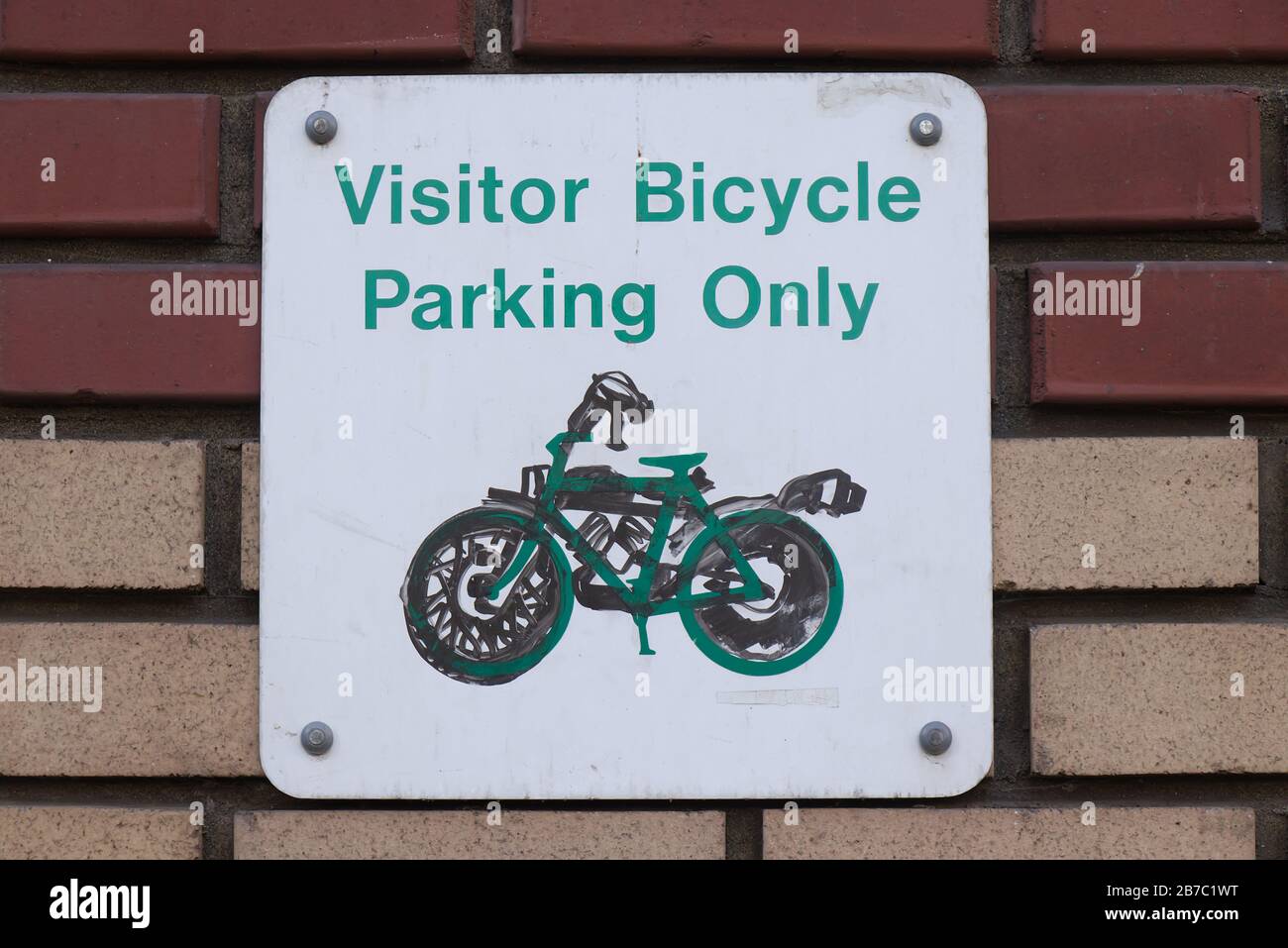 View of sign on the brick wall 'Visitor Bicycle Parking Only' in Downtown Vancouver Stock Photo