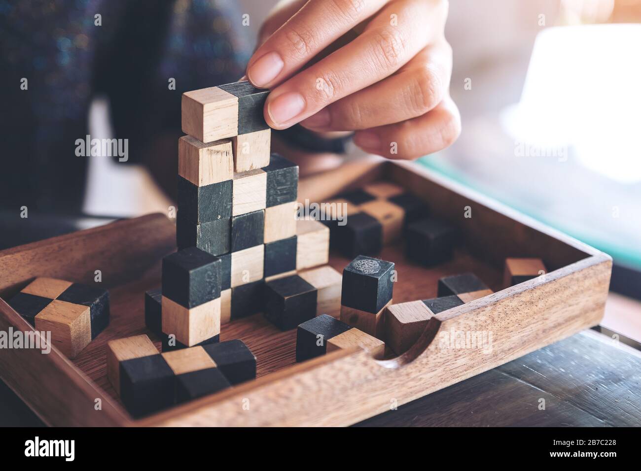 Closeup image of people playing and building wooden puzzle game Stock Photo  - Alamy