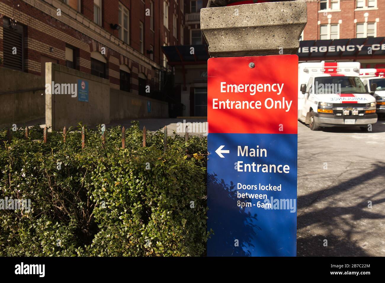 Vancouver, Canada - February 20, 2020: Close up view of Vancouver St. Paul Hospital emergency sign in red with directional arrow Stock Photo