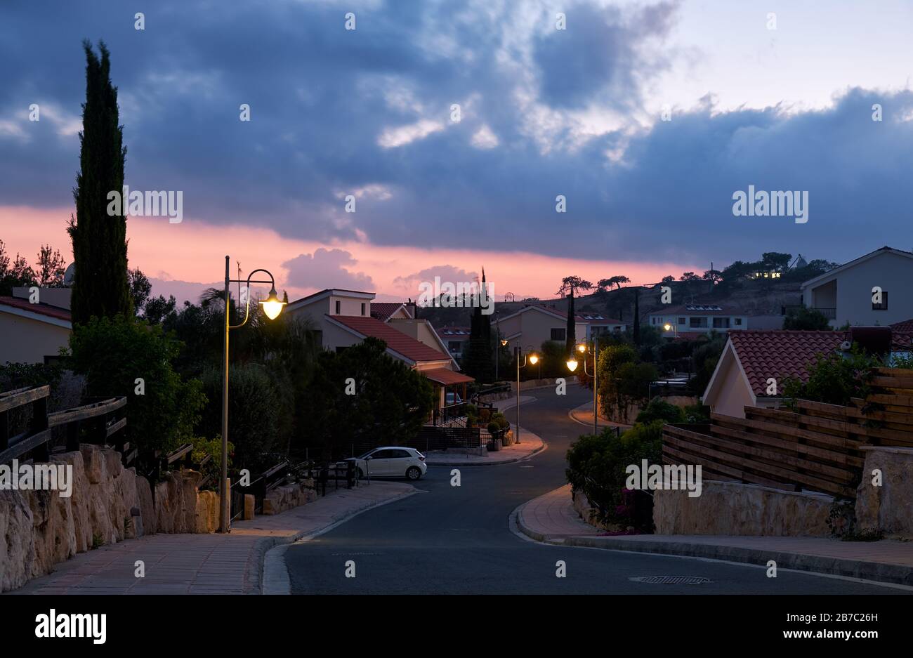 The view of the street with the line of residential houses of Pissouri village in the evening light. Limassol district. Cyprus Stock Photo