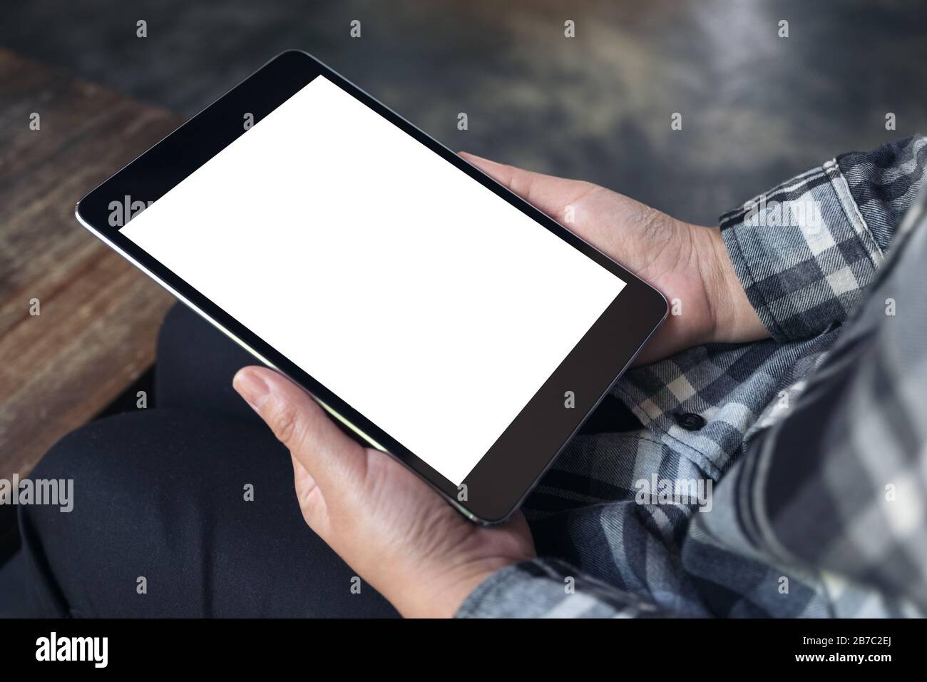Mockup image of hands holding black tablet pc with white blank screen ...
