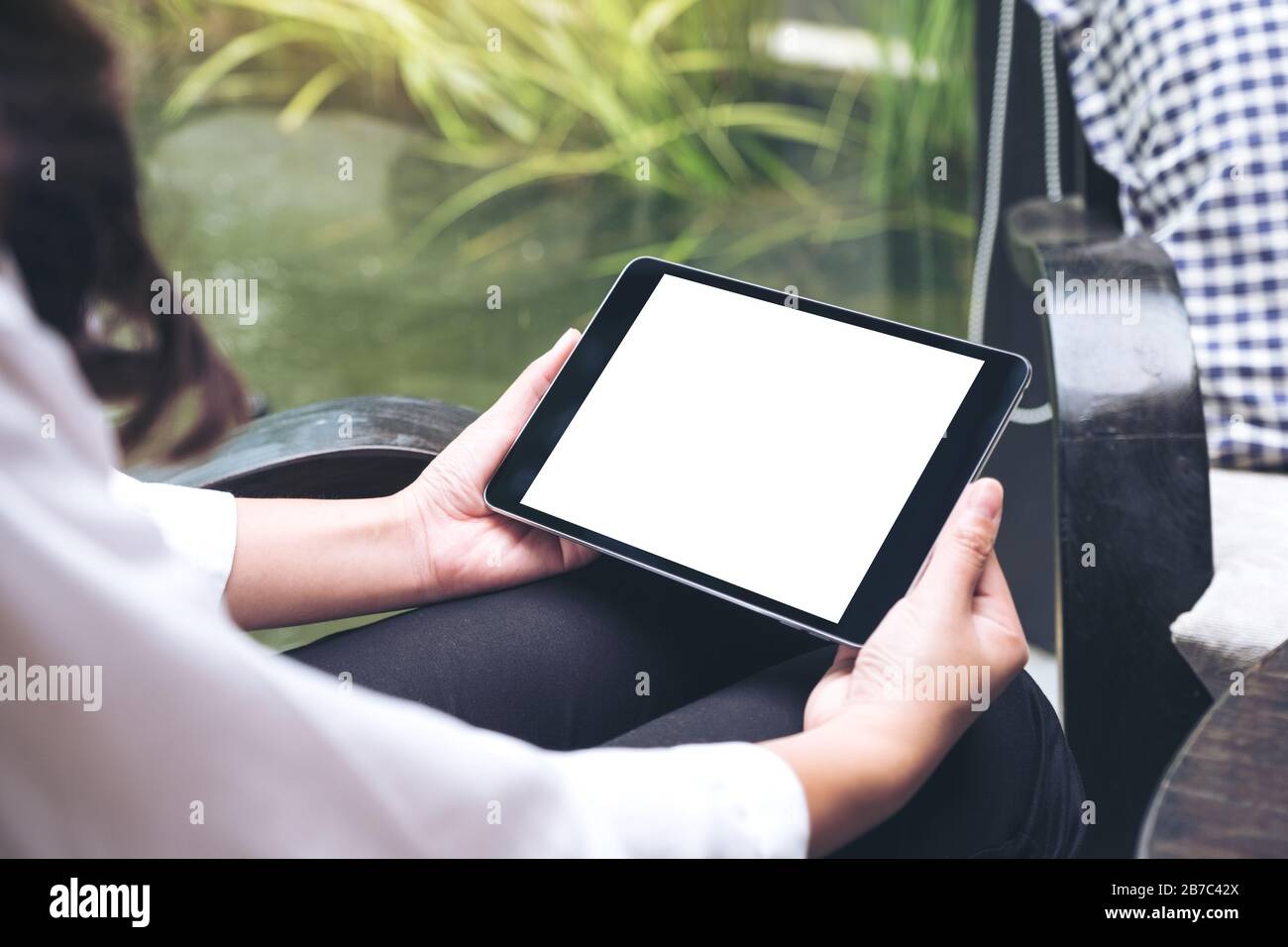 Mockup image of woman's hands holding black tablet pc with blank white ...