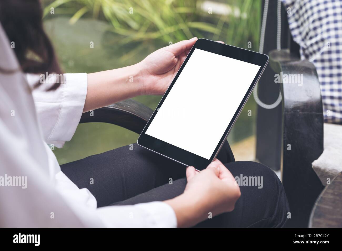 Mockup image of woman's hands holding black tablet pc with blank white ...
