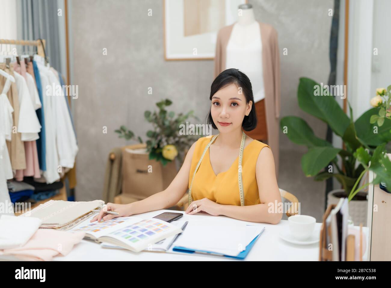 A young fashion designer working on her atelier Stock Photo - Alamy