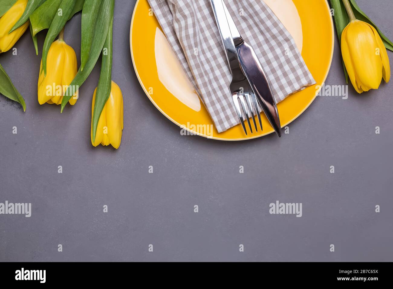 Festive table with yellow tulips. Stock Photo