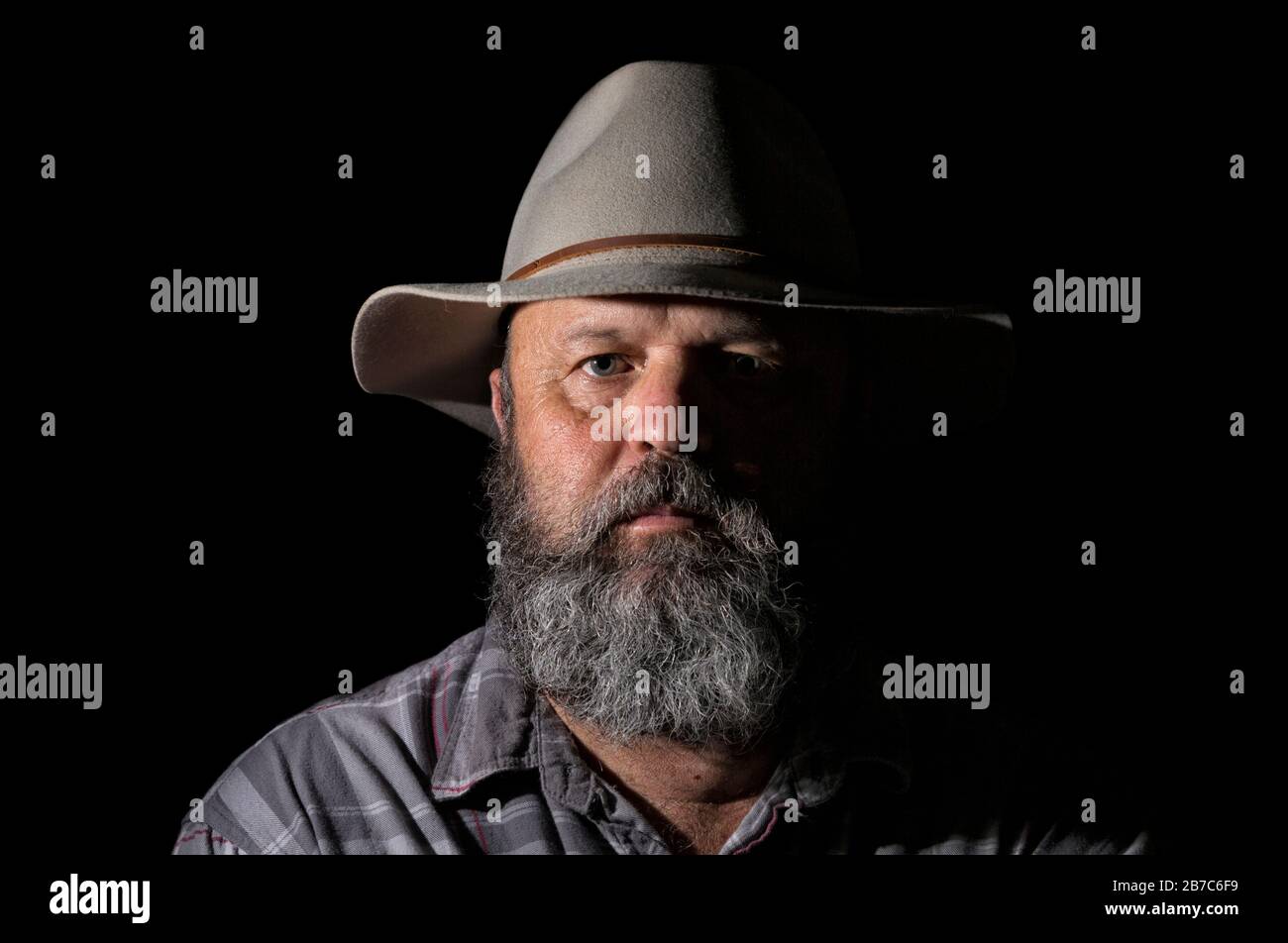 A studio portrait of a fifty to sixty year old agricultural worker on a ...