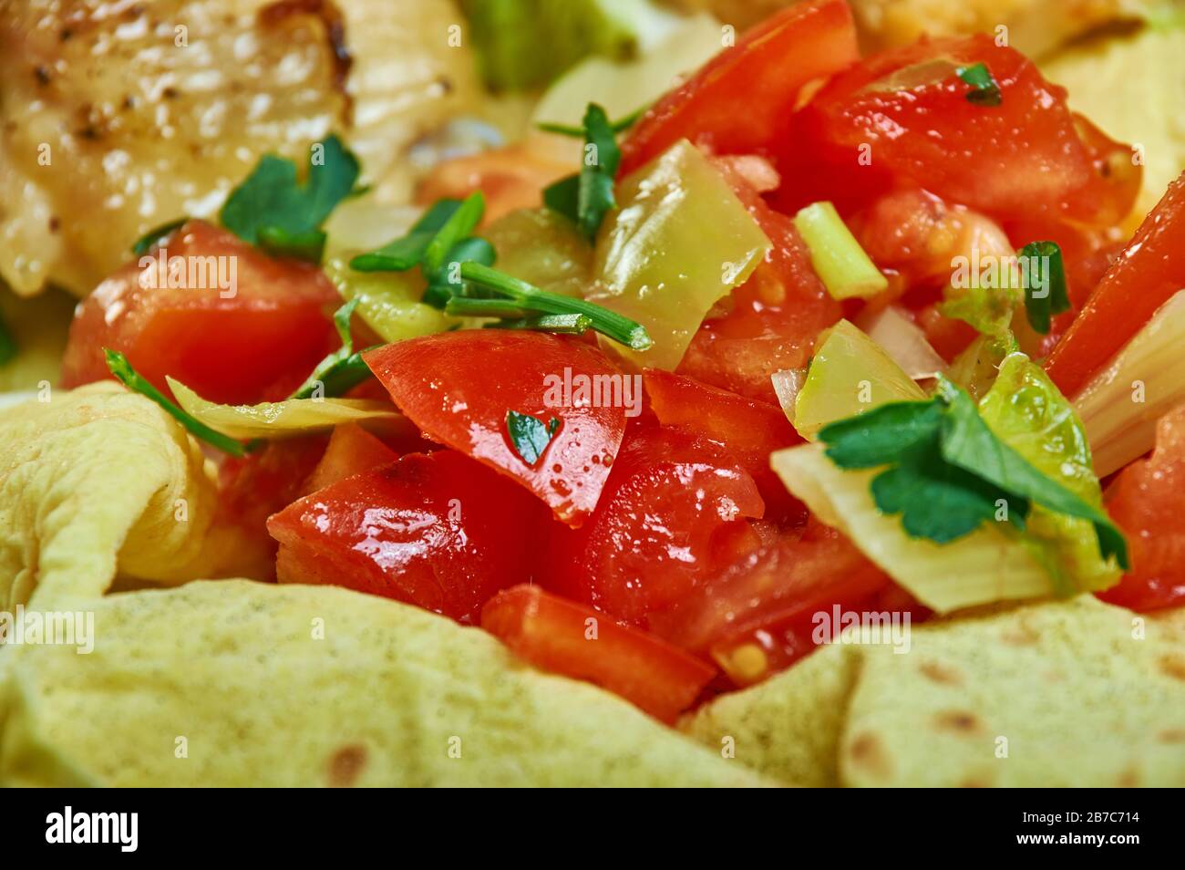 Timatim Salata, popular in Eritrea, Ethiopian cuisine, Traditional assorted African dishes, Top view. Stock Photo