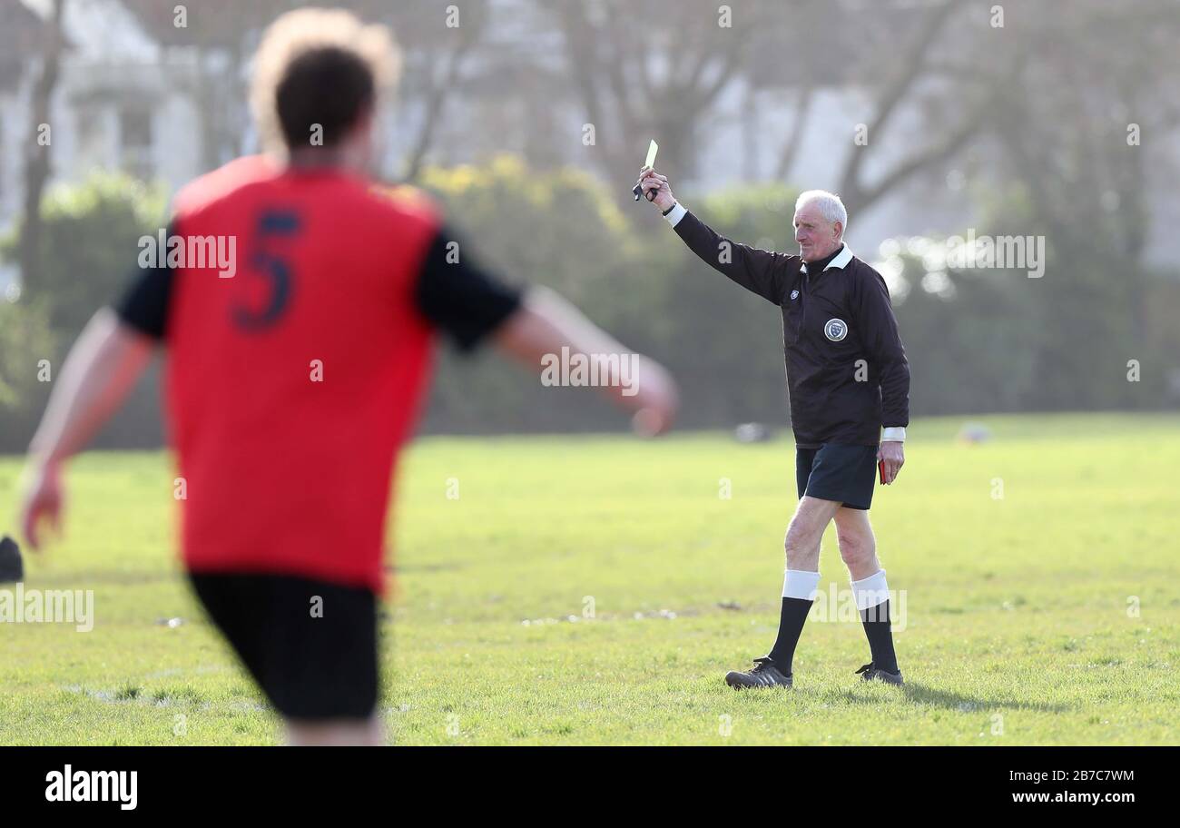Brighton, UK. 14th Mar, 2020. Referee show a yellow card - Despite the postponement of all Premier League and English Football League matches until 4th April in the United Kingdom due to coronavirus, there's was no stopping Grassroots football as The Lectern Lights took on Goring St Theresa's in the Chairman Charity Cup tie at Wish Road Recreation Ground, The Lectern were the convincing winners beating Goring 9-1Hove. Credit: James Boardman/Alamy Live News Stock Photo