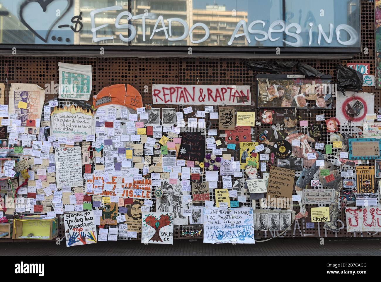Political posters and notes of protests in Chile on a wall in Santiago, Chile Stock Photo