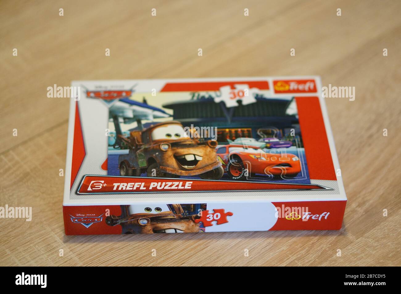 POZNAN, POLAND - Mar 03, 2020: Trefl Cars movie puzzle in a box on a wooden  table Stock Photo - Alamy