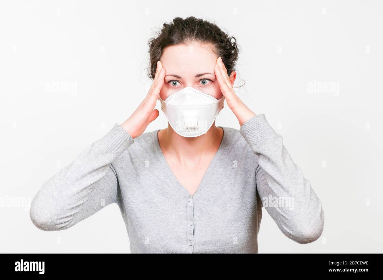 caucasian brunette woman in protective medical mask on face protection for spreading of disease virus SARS-CoV-2, Coronavirus, COVID-19. Stock Photo