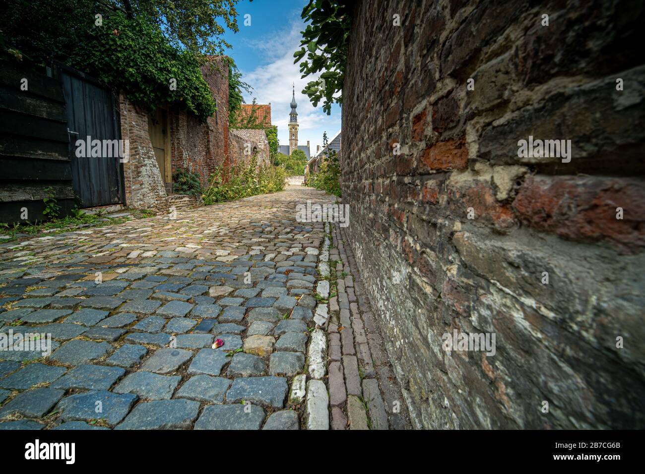High Angle Shot Of A Stoned Alley Surrounded By Bricked Walls With A Tower In The Background Stock Photo Alamy