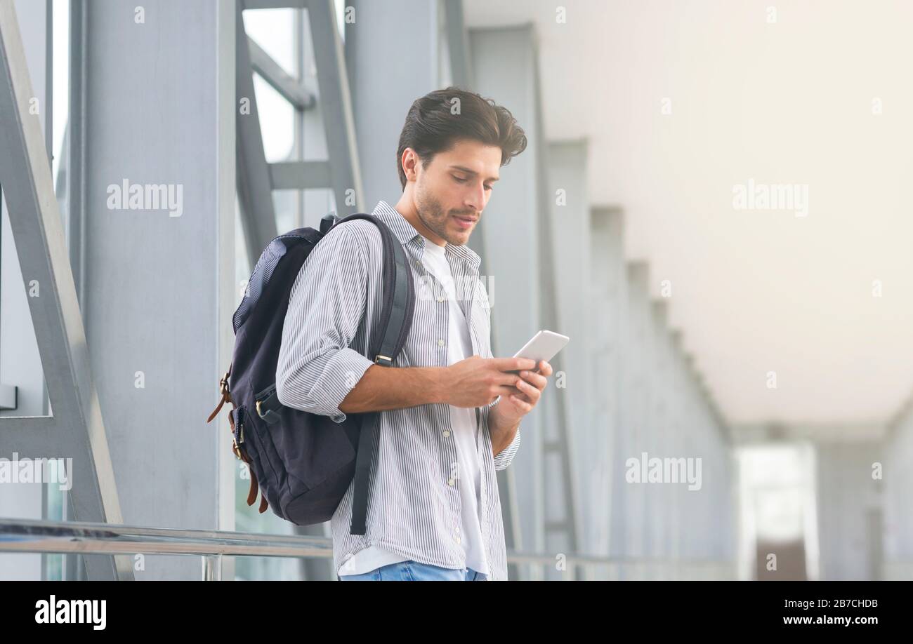 Online Check In. Man With Backpack Using Smartphone In Airport Terminal ...