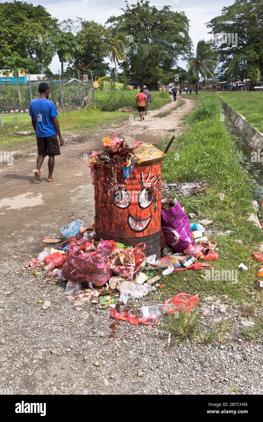 dh  MADANG PAPUA NEW GUINEA Local men walking path Waste bin with Betel juice stains people litter Stock Photo
