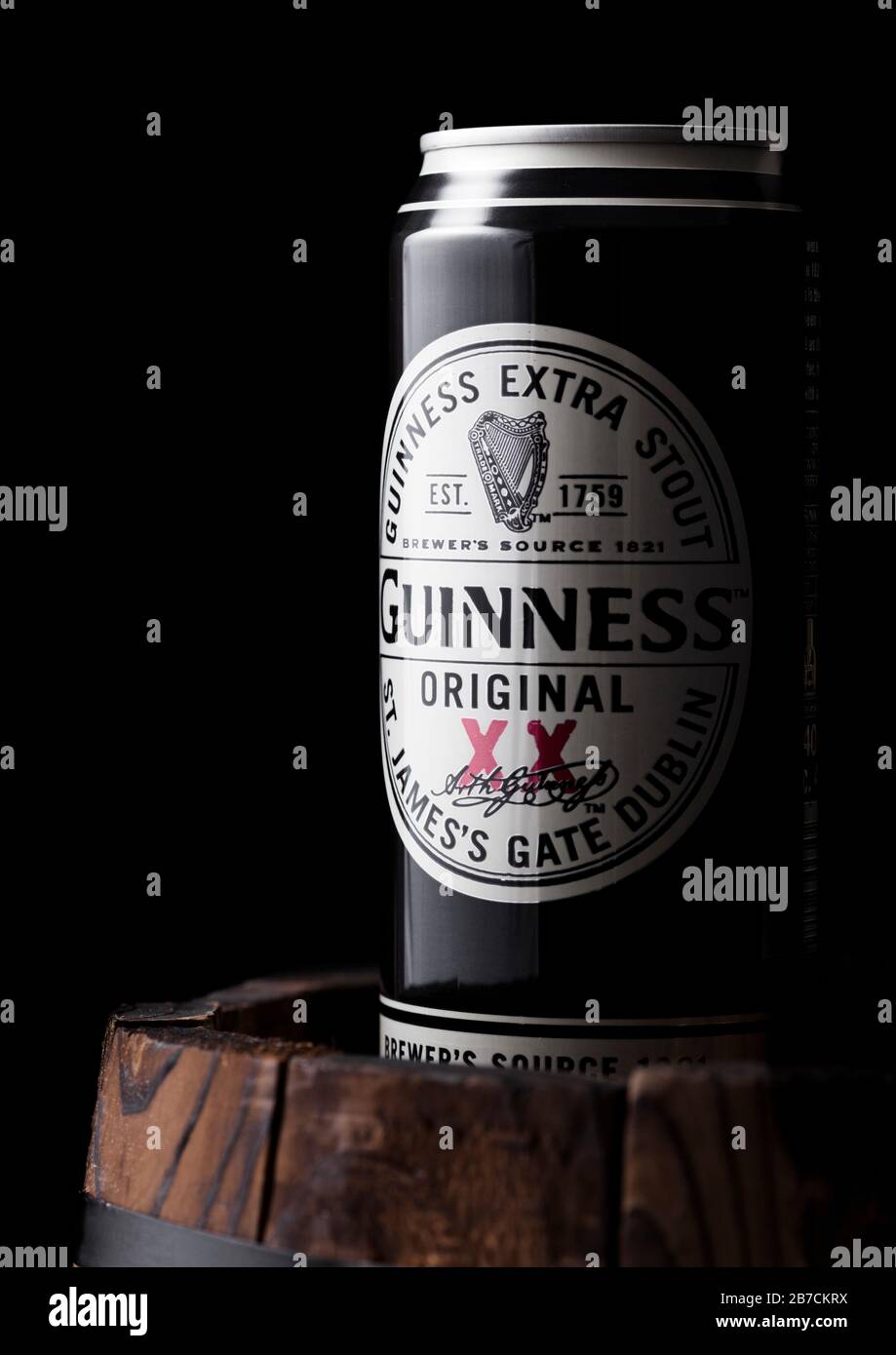 LONDON, UK - APRIL 27, 2018: Aluminium can of Guinness original stout beer on top of old wooden barrel. Guinness beer has been produced since 1759 in Stock Photo