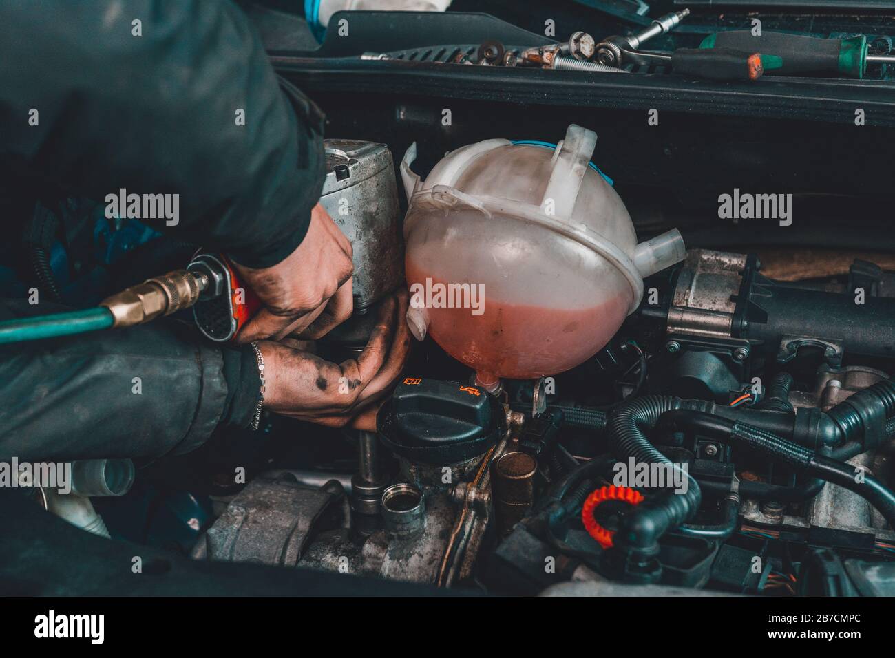 the master repairs the engine in the car service during a malfunction