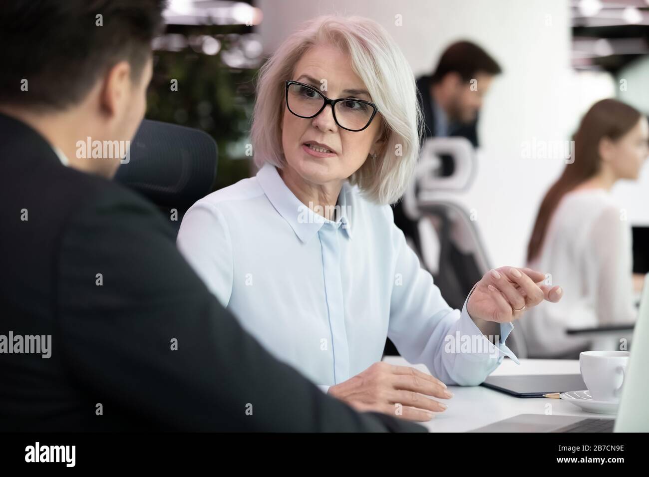 Discess Image Female employee brainstorm discuss business ideas with coworker Stock ...