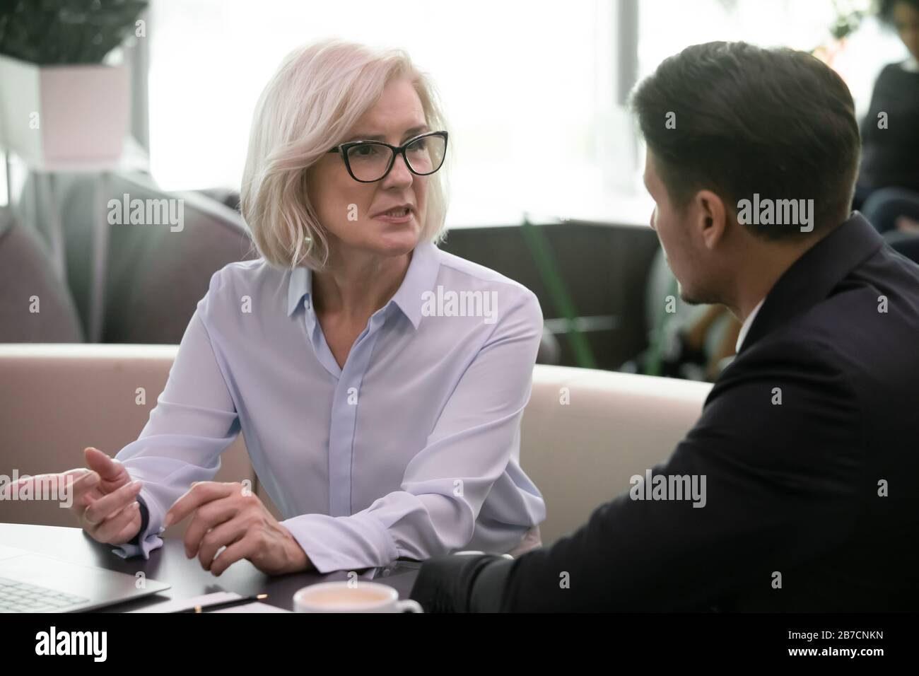 Diverse businesspeople brainstorm discuss ideas at briefing Stock Photo
