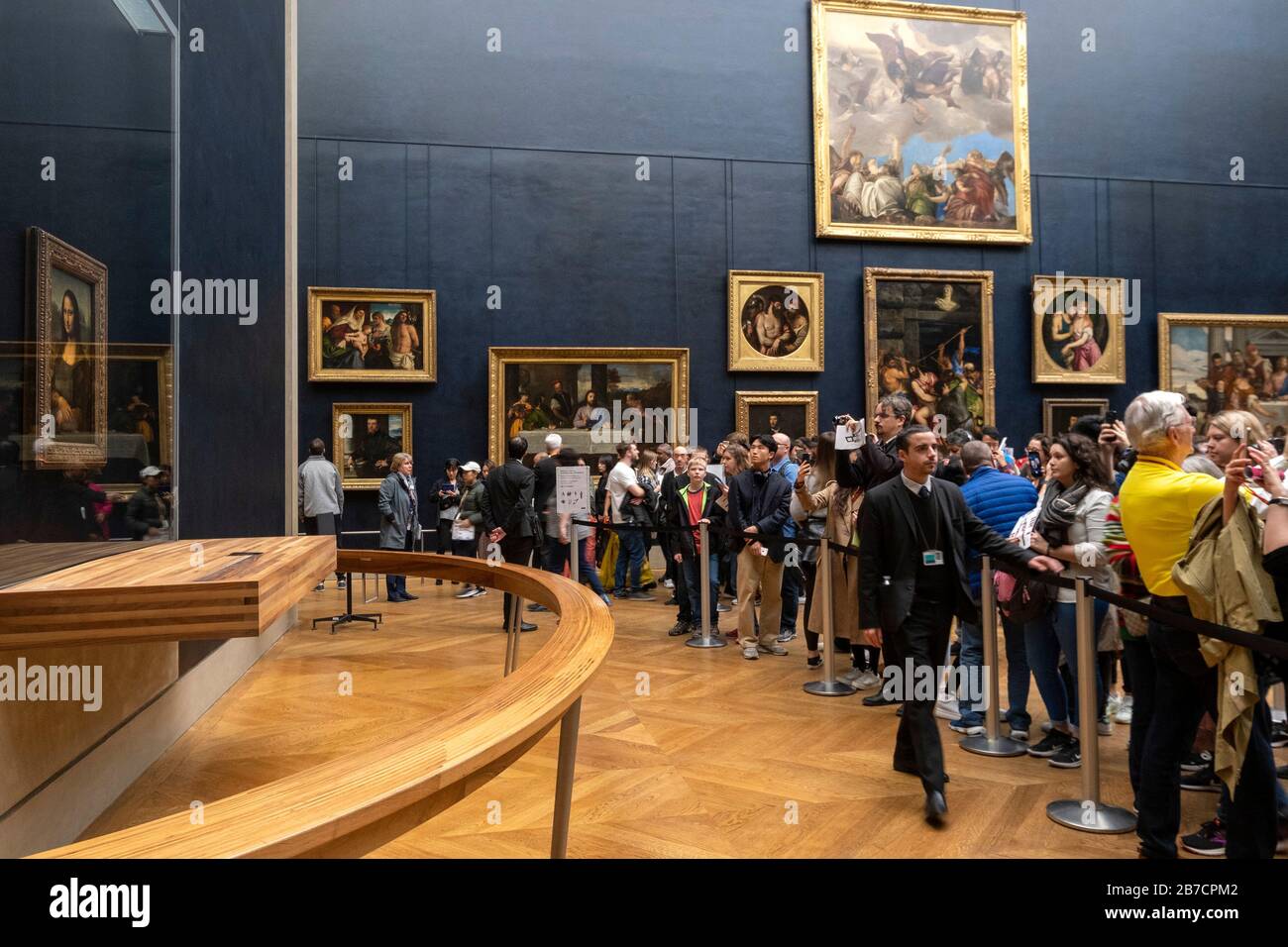Tourists queuing to take pictures of the Mona Lisa painting by italian artist Leonardo da Vinci at the Louvre Museum in Paris, France, Europe Stock Photo