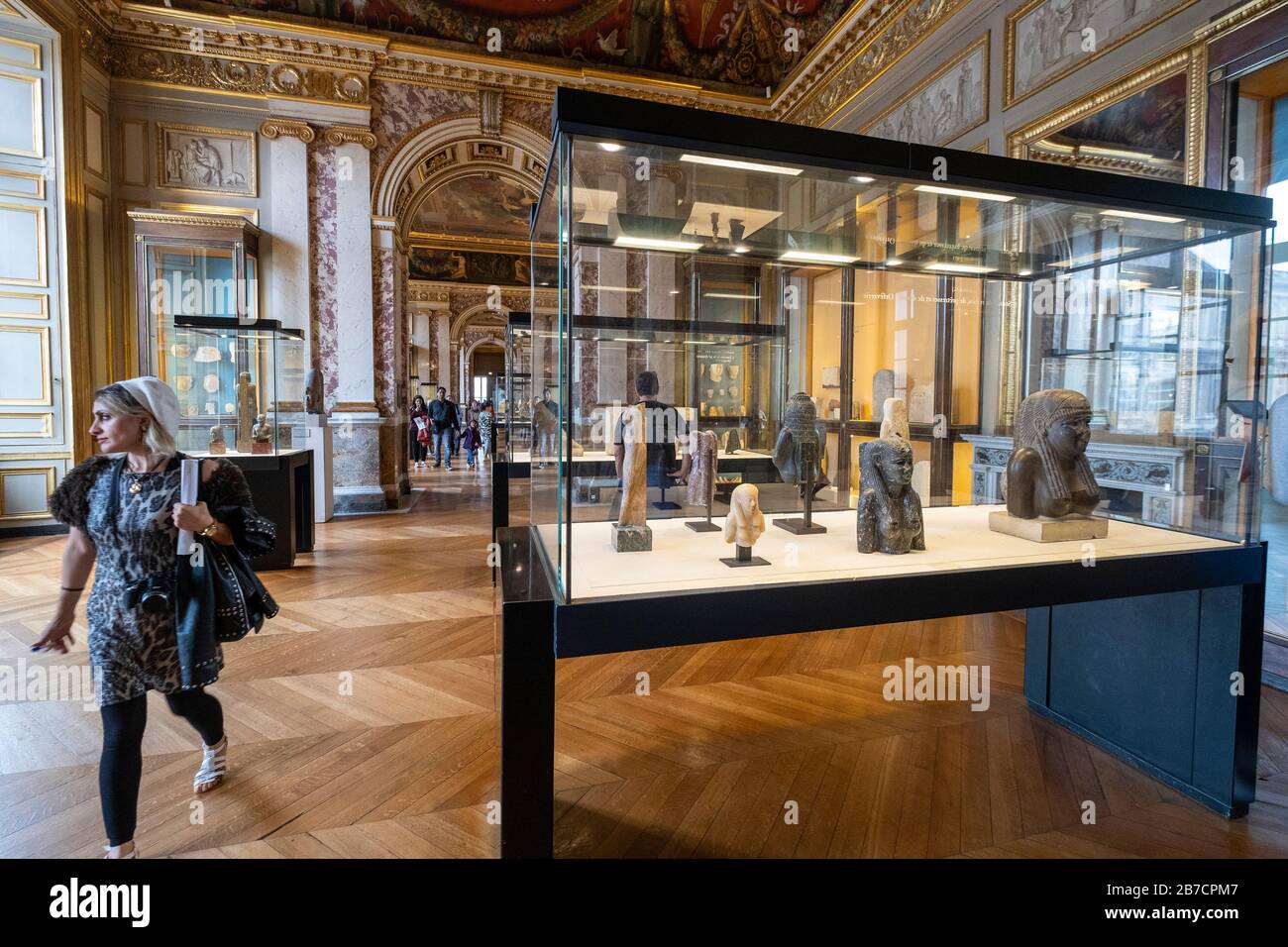 Young woman visiting the ancient Egyptian art section of the Louvre Museum in Paris, France, Europe Stock Photo