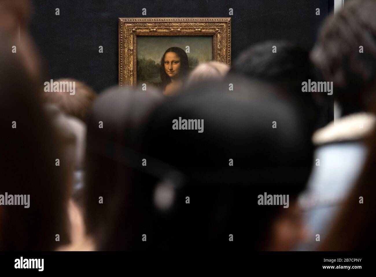 Crowd of tourists queuing to take pictures of the Mona Lisa painting by italian artist Leonardo da Vinci at the Louvre Museum in Paris, France, Europe Stock Photo