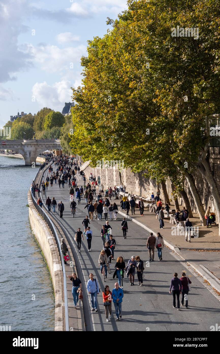 Pedestrians walking along the Seine river quayside in Paris, France, Europe Stock Photo