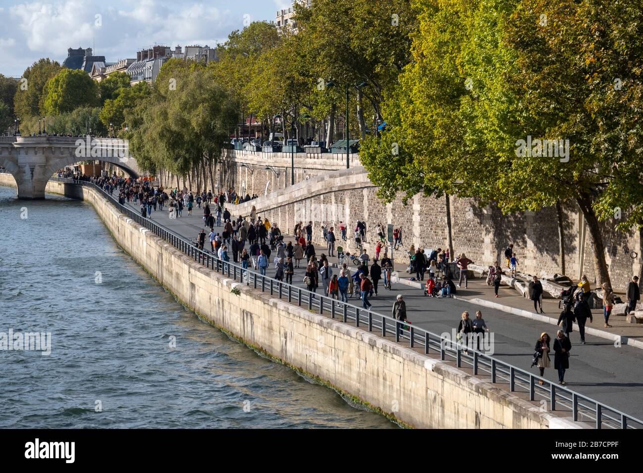 Pedestrians walking along the Seine river quayside in Paris, France, Europe Stock Photo