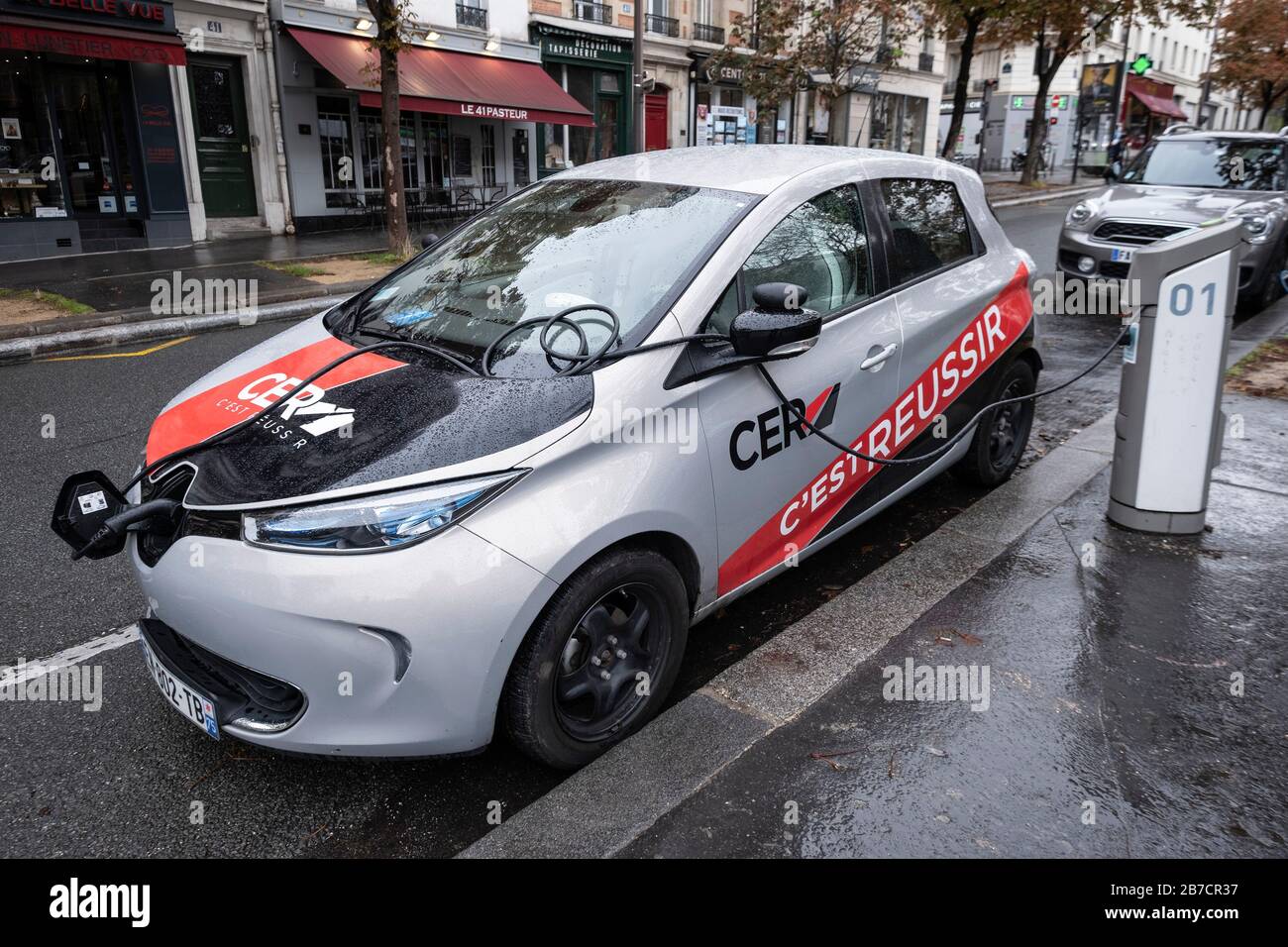 CER driving school Renault Zoe electric car charging on a public charger on  the streets of Paris, France, Europe Stock Photo - Alamy