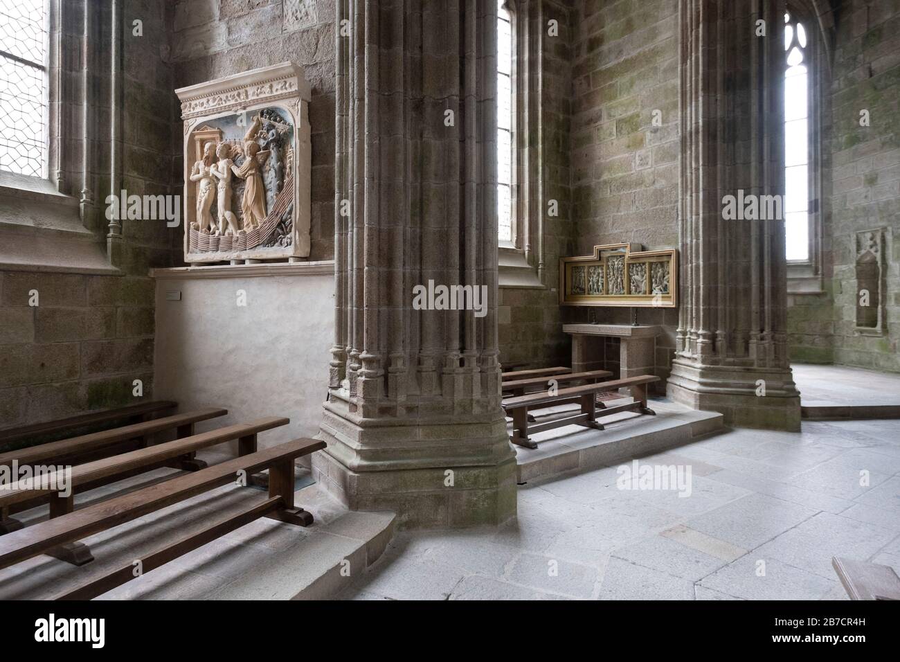 Pews and religious art inside the abbey at Mont Saint-Michel, Normandy, France, Europe Stock Photo