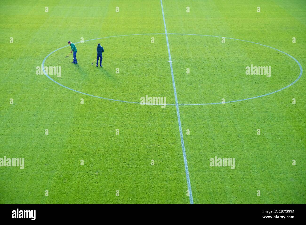 maintenance of the football field, manual grass adjustments using the