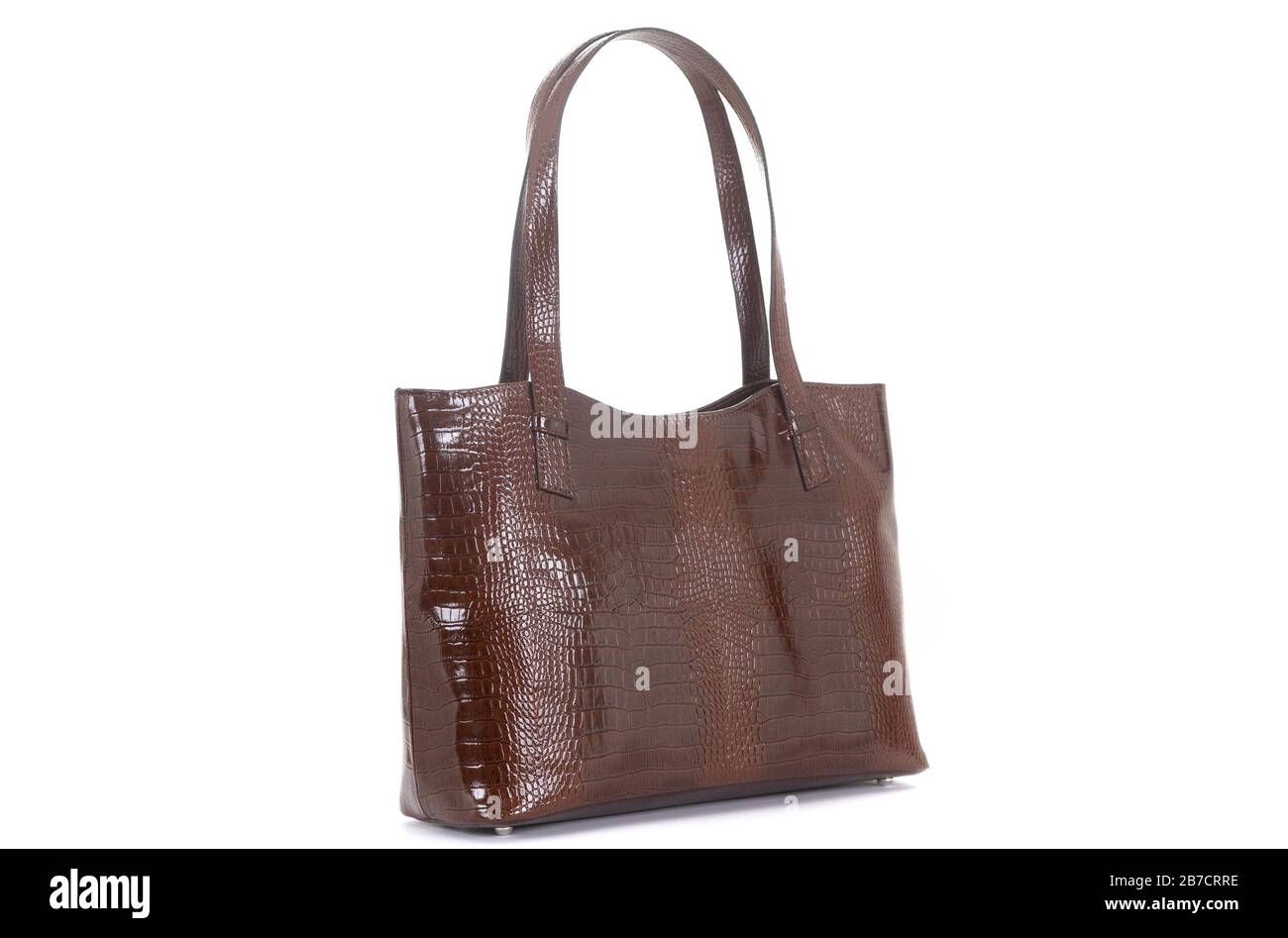 leather female brown bag on the handle sideways on a white background ...