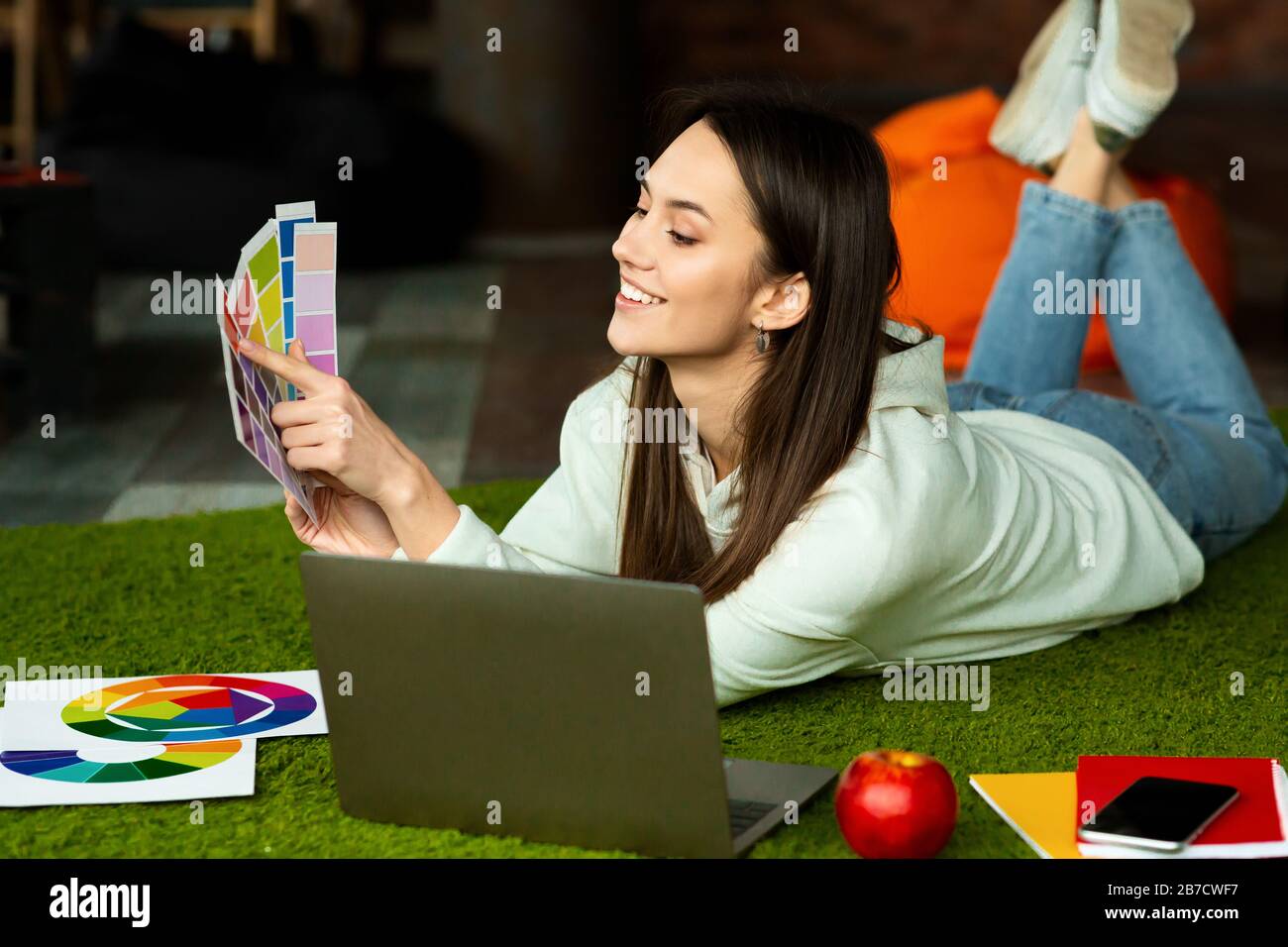 Work comfortably concept. Woman freelancer holds color swatch Stock Photo