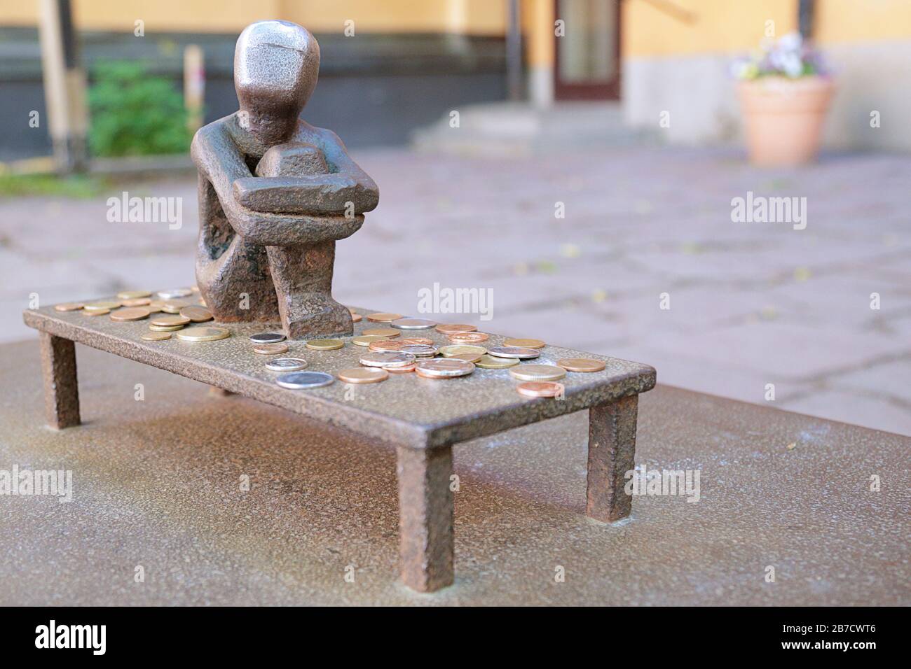 Stockholm, Sweden -  June 21, 2019: Jarnpojke or Iron Boy known as the little boy who looks at the moon is a tiny sculpture in Gamla stan Stock Photo