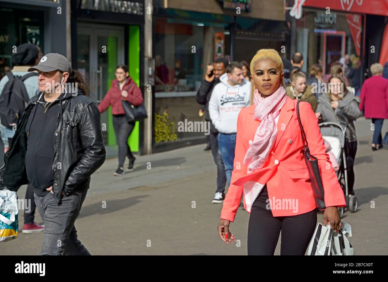 Young black lady, with tinted hair & pink jacket. Stock Photo